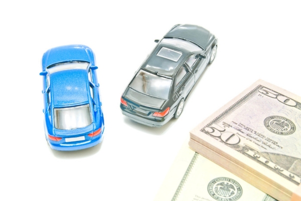 Black and blue miniature cars near the bills depicting convenience and affordability