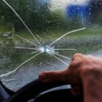 driving with a cracked windshield under the rain