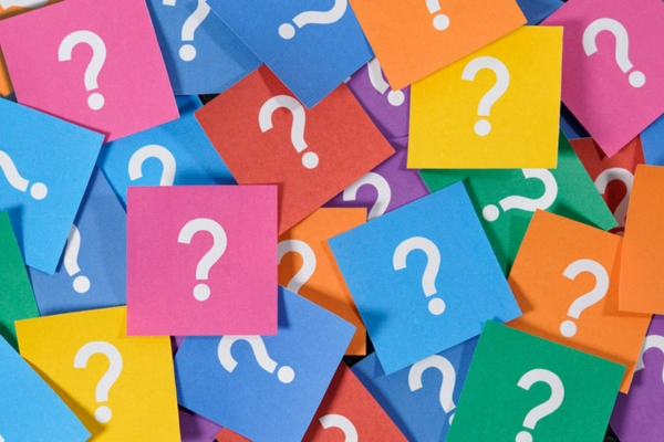 question marks on colored papers depicting Windshield Pitting FAQs