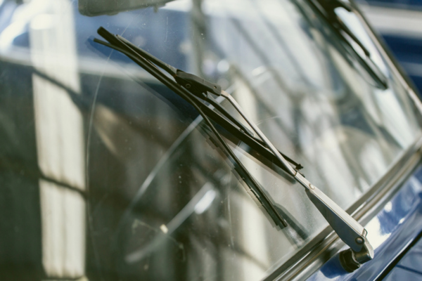 close up of windshield and wiper of a vintage car