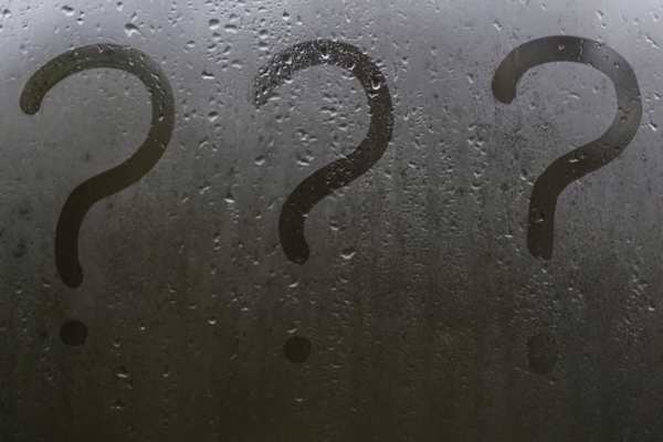 3 question marks doodled on a sweaty glass surface