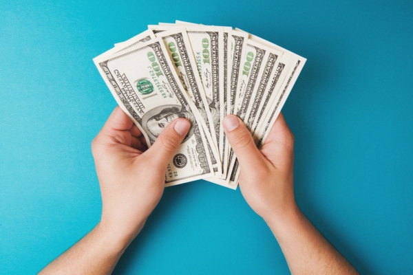 man's hand counting money