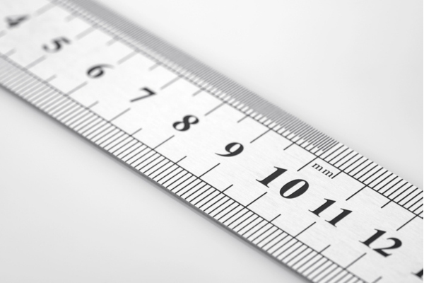 metal ruler on white background depicting windshield chip assessment