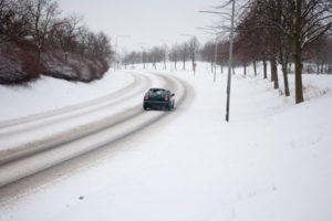 image of a car driving in winter weather