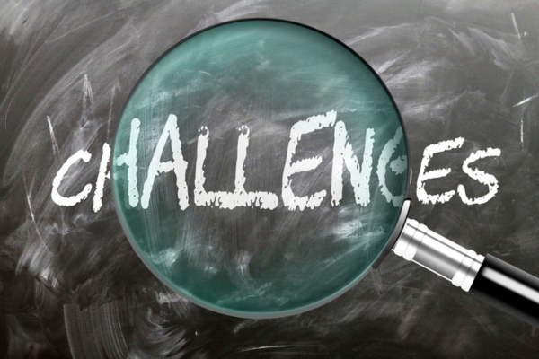 challenges written on a chalkboard highlighted by a magnifying glass depicting Smart Windshields