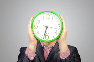 image of a car owner with clock depicting how long does a windshield replacement take