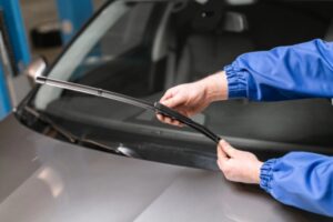 technician replacing windshield wipers