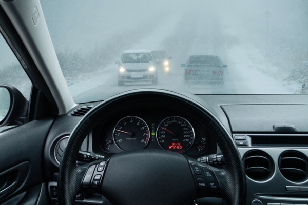 image of a car on the road in winter taken from inside