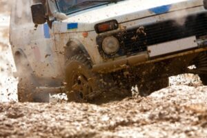 off-road vehicle rolling in mud