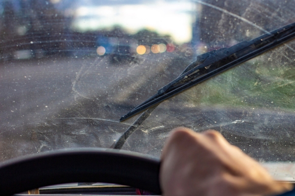 dirty windshield with hard water stains, dust, and scratches