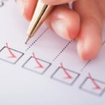 checklist on paper depicting summer road trip auto glass checklist