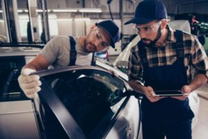 Auto glass Professionals Assessing Car Glass Damage