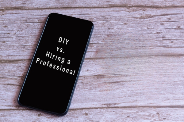 DIY vs hiring a professional auto glass shop displayed on mobile phone depicting car window repair