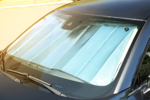 sun shade on car depicting temperature effects on auto glass