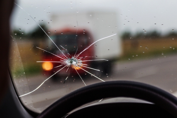 Broken windshield of a car depicting Physical stress