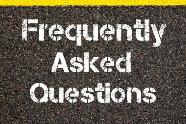 Frequently Asked Questions spray painted on concrete depicting Auto Glass Repair Shop