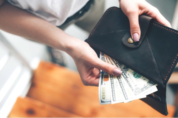 man bringing out money from his wallet depicting auto glass service price and cost-effectiveness