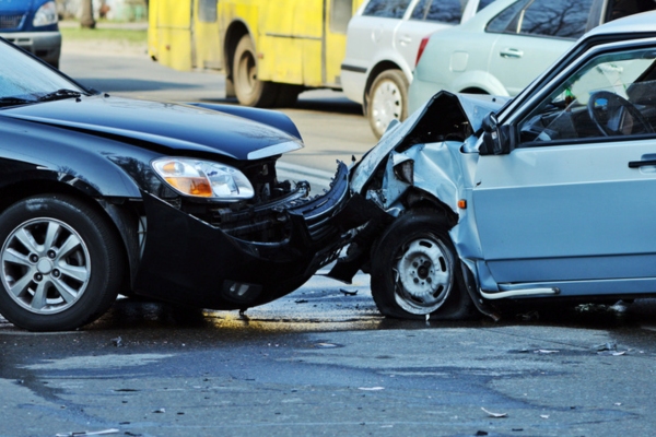 image of 2 cars with broken bumpers after a head on collision