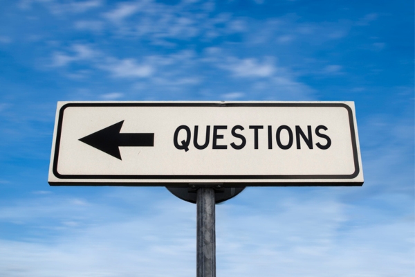 questions road sign with left arrow depicting FAQs about auto glass service