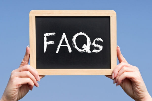 FAQs written on a mini chalkboard depicting questions about Windshield Installation Aftercare