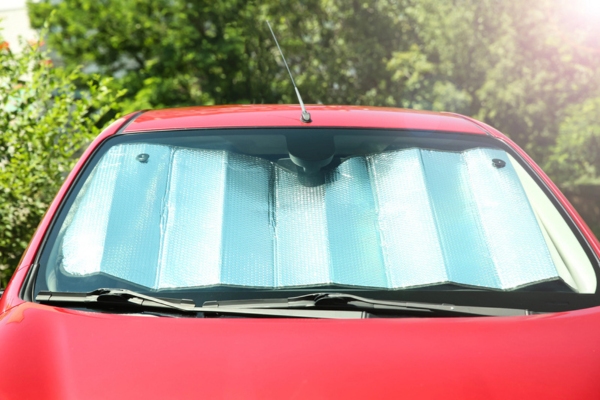 red car with sunshade on the windshield