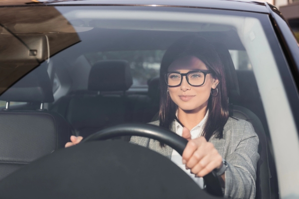 woman driving car with newly installed windshield