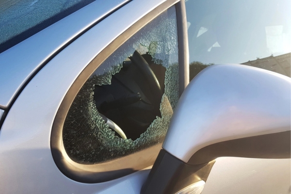 damaged side glass of a vehicle beside a side mirror