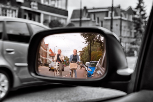 people biking seen on the side mirror