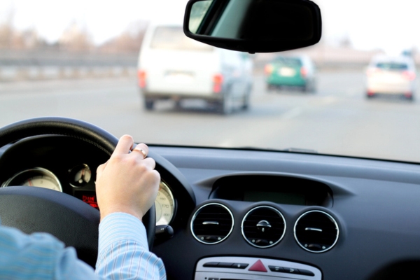 man driving along the highway while maintaining a good following distance