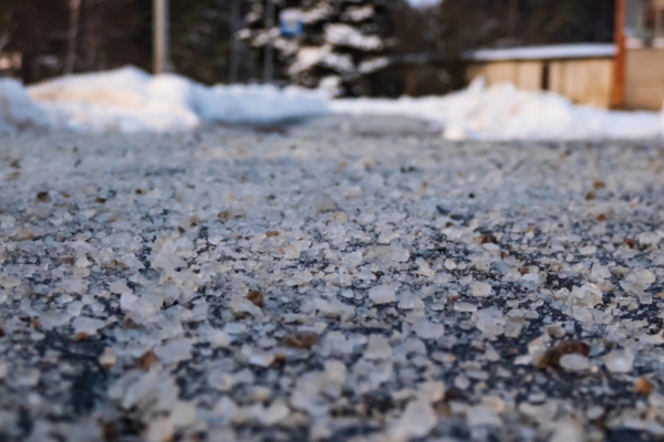 salt grains on icy sidewalk