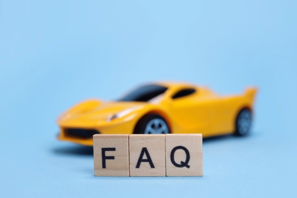 FAQ spelled using wooden letter cubes standing in front of a toy car depicting Windshield Temperature Change questions