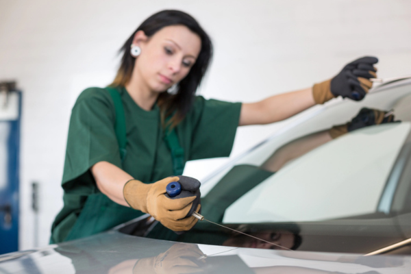mechanic tending to a windshield